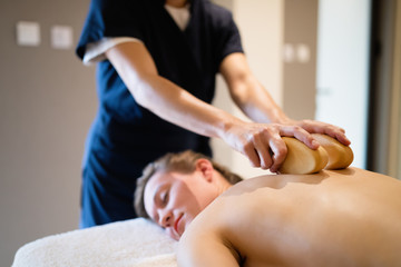 Obraz na płótnie Canvas Cliend enjoying massage given by masseur