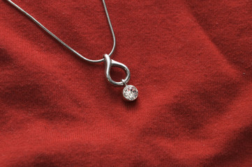 Fototapeta na wymiar Jewelry chain on a red background