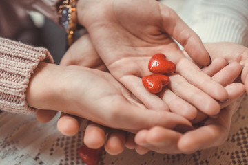 Couple colding two hearts in their hands; couple in love; Valentine's Day background