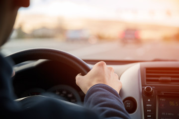 Driving car hands on steering wheel