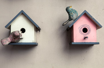 two small bright bird houses, spring background