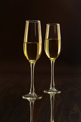 Glasses with white wine on blurred background