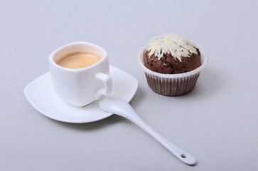 Classic style espresso shot with chip muffin and coffee beans on white background.