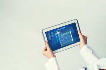 Close of female doctor hands working with tablet pc computer