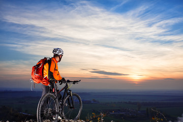 cyclist on mountain-bike  background of beautiful sunset.