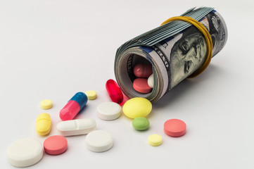 Colored pills with money. Health costs a lot