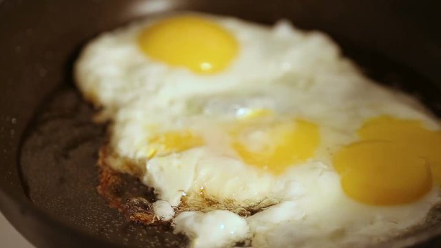 Close up shot of Preparing scrambled eggs on hot frying pan