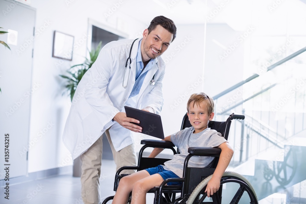 Canvas Prints Doctor showing digital tablet to  disable boy