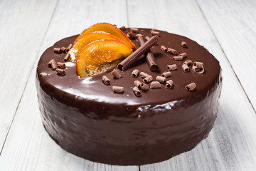 chocolate cake with Candied Oranges,Chocolate cake with a cut piece and blade on gray background, closeup,Dark chocolate cake,Delicious vegan chocolate cake,Tasty chocolate cake on wooden background