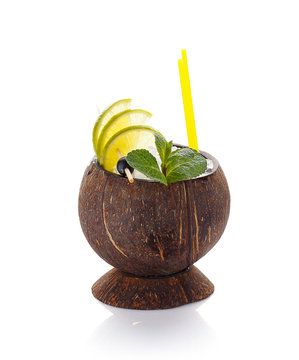 Fresh fruit cocktail in coconut with ice isolated on white background