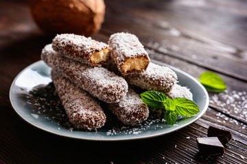 Savoiardi covered in chocolate and coconut