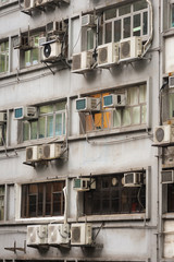Fototapeta na wymiar Hong Kong Apartments. The back side of an apartment building in central Hong Kong is a graphic mass of windows and air conditioners. 