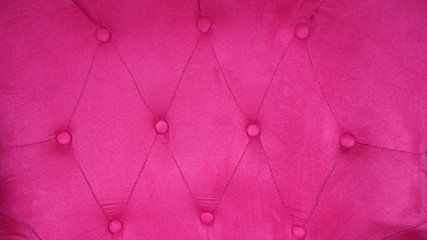 Furnishings sofa with fuchsia or pink upholstery. 