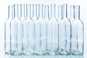 Dozen empty bottles arranged chess-board fashion