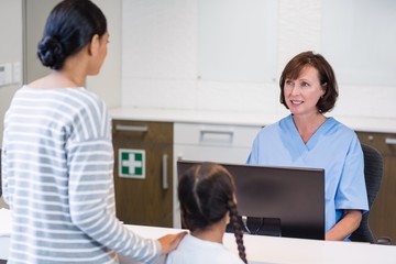 Nurse talking with a patient at counter