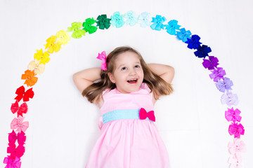 Obraz na płótnie Canvas Little girl with colorful bow. Hair accessory
