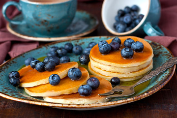 Delicious homemade pancakes with juicy berries and sauce