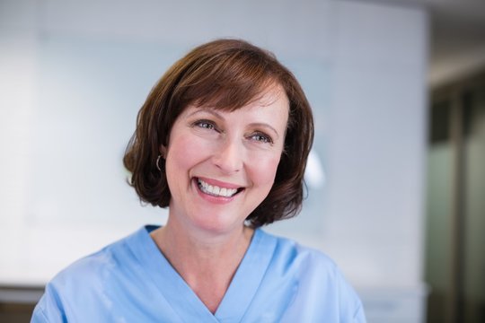 Smiling nurse sitting at desk