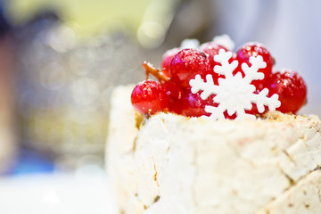 The decoration on the dessert of red currant and snowflakes.