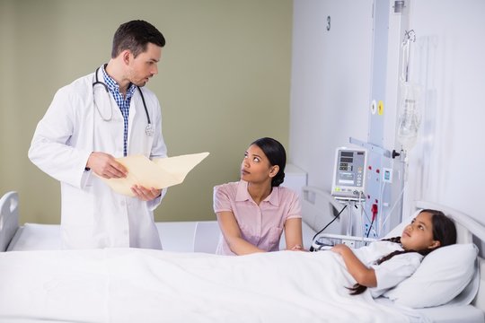Doctor and nurse interacting with girl patient