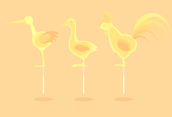 Caramel yellow candy on a stick in the form of cartoon animals/ birds