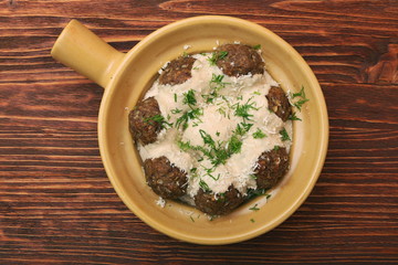 Meatballs with cream sauce in a ceramic pan