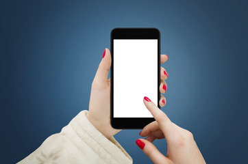 Women holding black mobile device in hand, touching empty white screen with finger, on blue background 