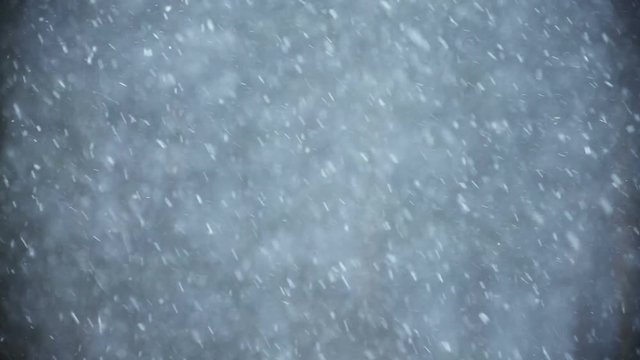Background of snow fall blowing fast in winter blizzard.