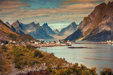 Panoramic view of the fishing village of Reine with dramatic sky.  Rocky beach, Lofoten islands, Norway