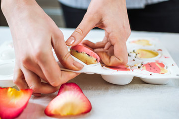 Pastry-cook puts out prepared candies in the form of hearts