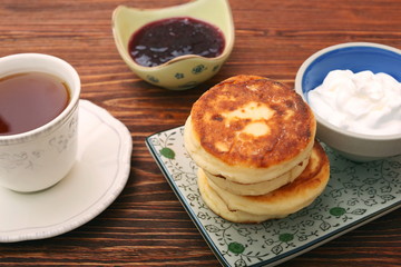 Cheese pancakes fried in a pan.