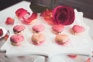 Candies in the form of hearts with rose petals around
