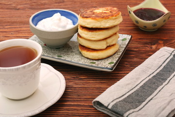 Cheese pancakes fried in a pan.