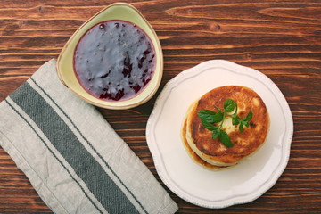 Cheese pancakes fried in a pan.