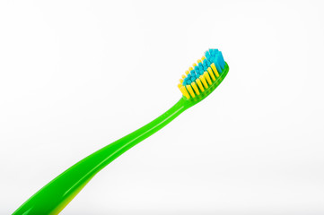 New green toothbrush. Studio shot isolated on white background