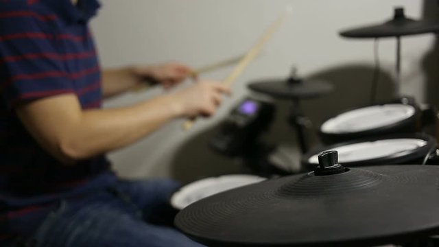 shot of drummer playing at the electronic drums kit