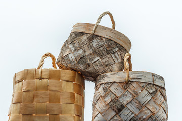 Wicker basket made of birch bark on a white background. National Slavic crafts. Handmade in a rustic style. A basket for berries, mushrooms, fruits, vegetables, for household