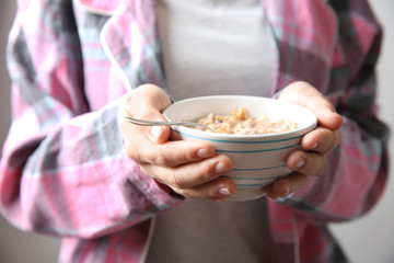 Obraz na płótnie Canvas Closeup of woman holding bowl with healthy breakfast