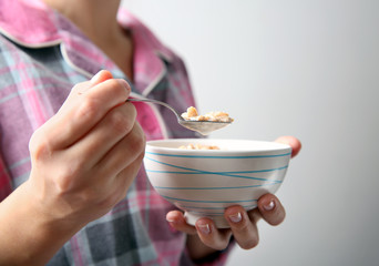 Closeup of woman holding bowl with healthy breakfast