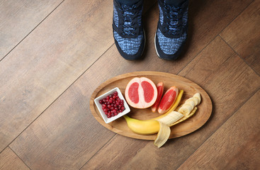 Woman with healthy breakfast on wooden board