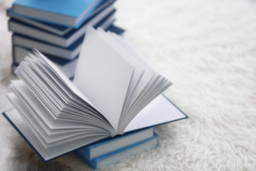 Pile of books on the floor at home, closeup