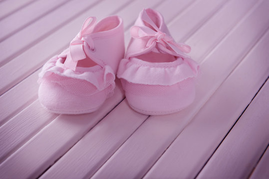 New children shoes on wooden background