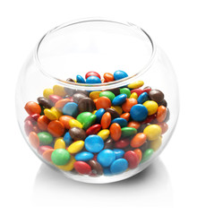 Colorful candies in glass vase on white background