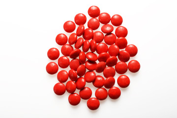 Red candies on white background