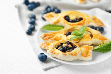 Tasty puff pastry with berries on plate