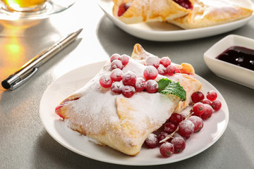 Tasty puff pastry with berries on plate
