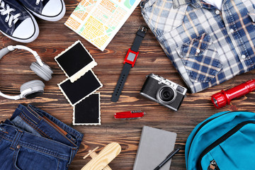 Outfit for travelling on wooden background