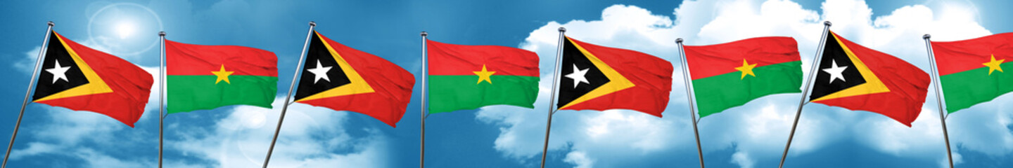 east timor flag with Burkina Faso flag, 3D rendering