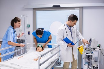 Doctors examining patient in ward 