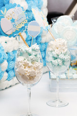 Small marshmallows in wine glasses decorated in a holiday style to the birthday boy